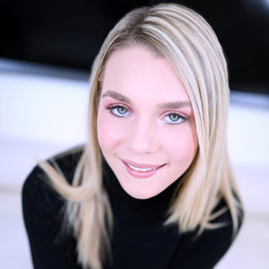 Blonde beauty looks hot in black dress