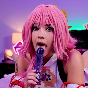 Sucking on her dildo