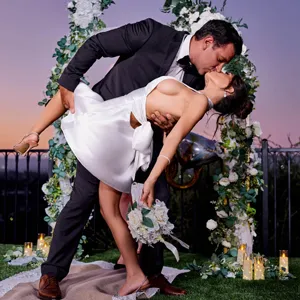 Bride Tru Kait kissing her husband