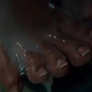 Creaming her feet