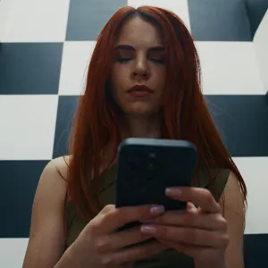 Sirena Milano watching her phone