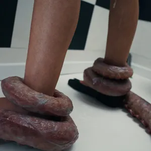 Tentacles holding her legs