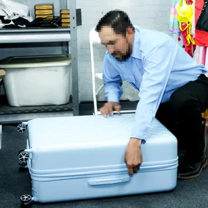 Juan opening the suitcase