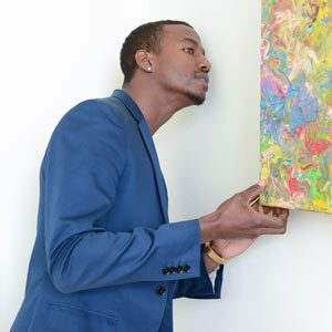 Axil looking behind the paintings