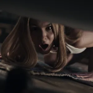 Alecia Fox looks under the bed to find a bug