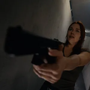 Clemence Audiard is pointing a gun at her
