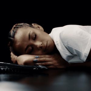 Veronica on the floor in a white shirt only